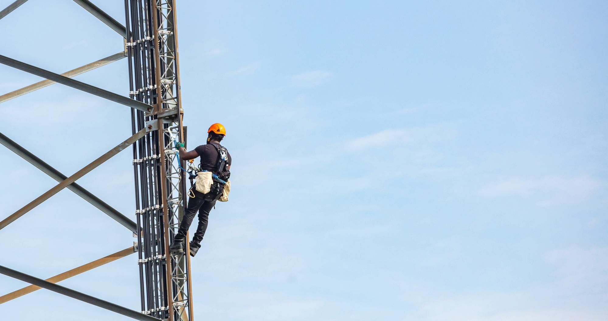 Technician installing an antenna at sunset