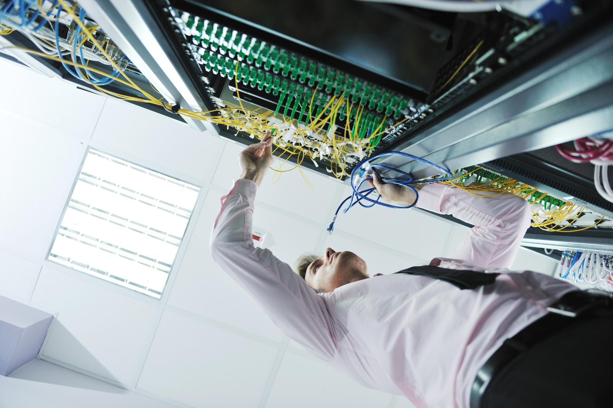 WZC engineer commissioning network equipment in a head-end room
